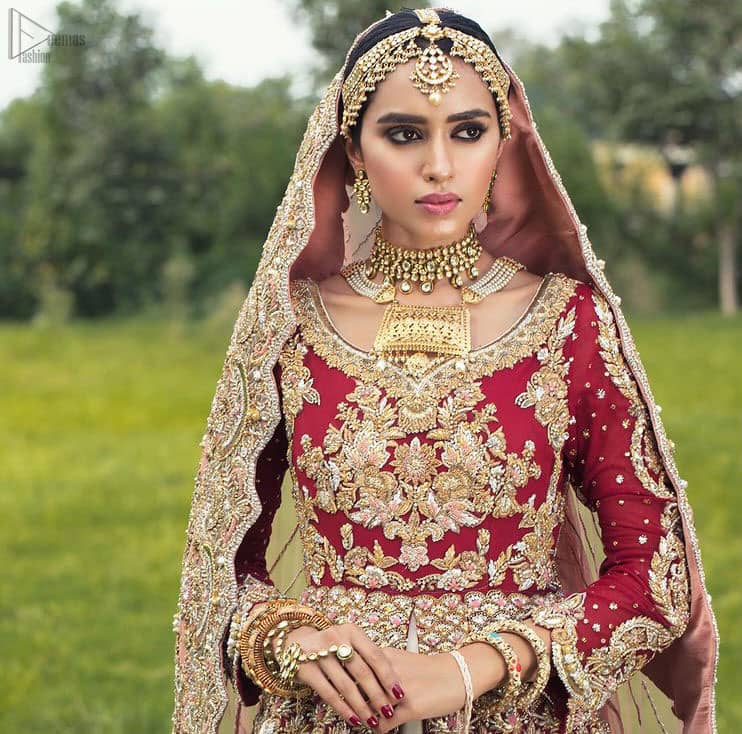 Best Nikah Dress - Red Front Open Gown Inner Ivory Lehenga Maxi. Glorify yourself by suiting up with the exceptional dress ranges from the house of DeemasFashion out of which one is here to make you graceful enough to make all jaws drop down. Red Organza with sweetheart necklined fully engraved, chantilly appliqued and giving a kind of look that you will surely love to have. Along with the elegant ivory coloured floral motifs having maxi lehenga in your drop-down menu of this gorgeous outfit. The fully embossed tea rose organza dupatta is giving major traditional vibes with scalloped borders that will surely suit your face beauty.