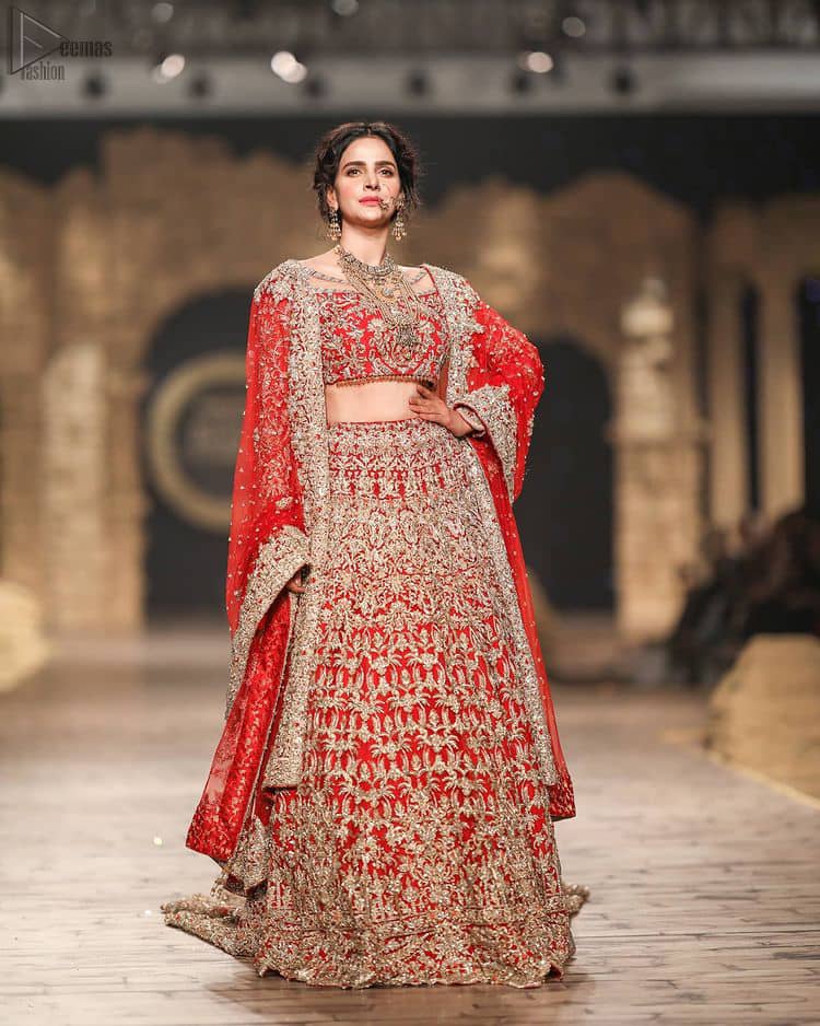Pakistani Wedding Wear having Red Short Blouse Lehenga. The dress constitutes a pure organza based blouse with a boat-shaped neckline, followed by a beautiful Lehenga.