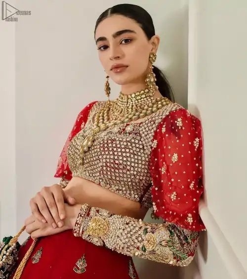 The red Lehenga Blouse comes with full sleeves and is made with the purest organza, while a sweetheart neckline follows