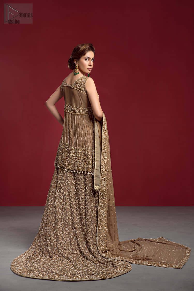 Captured in a traditional silhouette, The bridal stands out due to its uniqueness and the perfect fusion of modern cut and traditional embroidery. This dress is beautifully decorated with heavy embroidery. It is highlighted with kora, dabka, tilla, sequins and pearls. The peplum is enhanced with zardosi work all over and tassels on the hemline. It comes with a full embellished lehenga adorned with a fully embellished back train. It is coordinated with an organza dupatta which is sprinkled with pearls all over it. It is further furnished with a four-sided embroidered border.