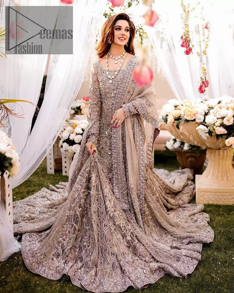 Embrace happiness on your Walima in the colour of beige-pink along this dreamiest fairy tail maxi. The floral fusion of tilla and thread embroidery on a royal beige-pink maxi is to fulfil your dreamy look. The boat shape neckline of this maxi is as amazing as the whole maxi. Further, it is fully embellished with tilla, kora, dabka and sequins work just to enhance the beauty of your Walima day. The fairy tale is also adorned with heavy work and looks super amazing when combine with full sleeves style. Finish this fairy look with the same colour dupatta that is ornamented with a four-sided border and sequins sprayed all over to increase the look of this article.