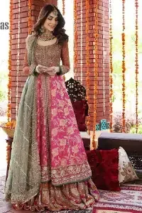 Be one with defying fashion winds and become a trendsetter. The captivating combination of front open style with the round neckline of shocking pink pishwas gives a stunning and smart look to you at any event. Pishwas is further furnished with attractive and handsome golden embroidery that includes mainly kora, dabka, and tilla work. Balance it with Rush Lehanga that have embellished with heavy border and sequins spray all-around to give soothing look. Complete this eventry look with a mint green dupatta that has been embellished with four-sided lace to give you a trendsetter look.