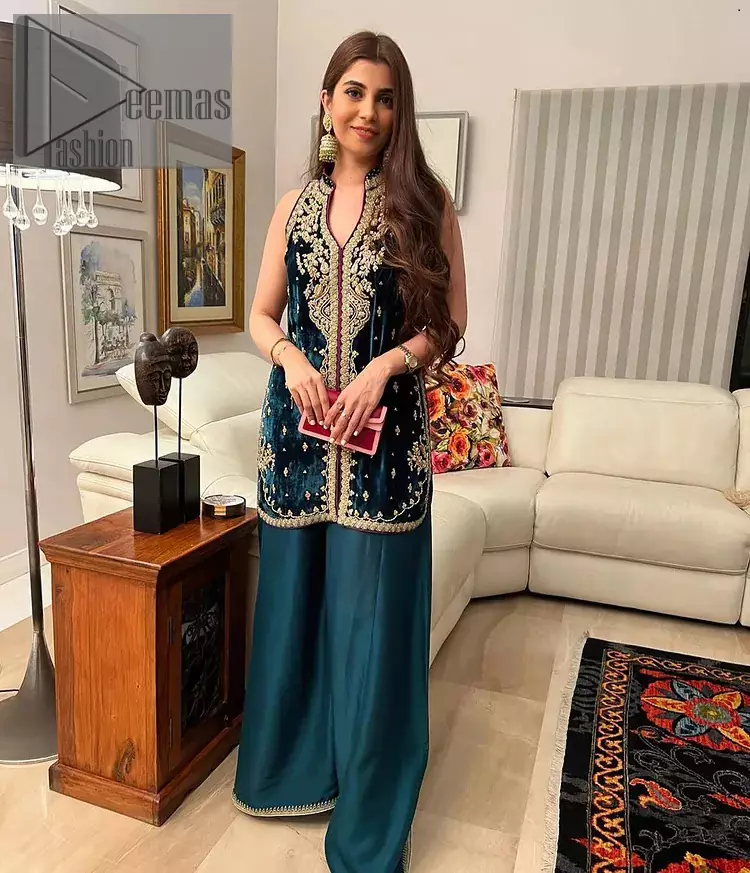 No matter the time and occasion, a pop of blue will always bring you in the bright light. This teal blue short shirt is an exquisite amalgamation of classical golden embroidery and modern cuts. It is prominent with tilla, dabka and kora so everyone looking at you in any event. The V shape neckline increases the beauty of the outfit when combined with the sleeveless style of DeemasFashion. Further, it is coordinated with the same colour palazzo pants that are the bottom line is embellished with golden tiny embroidery to enhance the brightness of your dress.