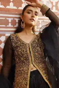 With the timeless charm of black so back on traditional flavour to steal everyone's heart. Introducing the black jacket that is the epitome of splendour with delicate details beautifully decorated with golden colour. The bodice of the jacket is enhanced with stunning embroidery with worked finishing of tilla, kora, dabka and zardozi. The addition of simple sleeves with V shape neckline can be done to make this super traditional. To complete this traditional jacket, a crushed sharara is added to give you an amazing look at any formal event. Complete this black outfit with a black dupatta in a plain style that is perfect for any intimate evening 