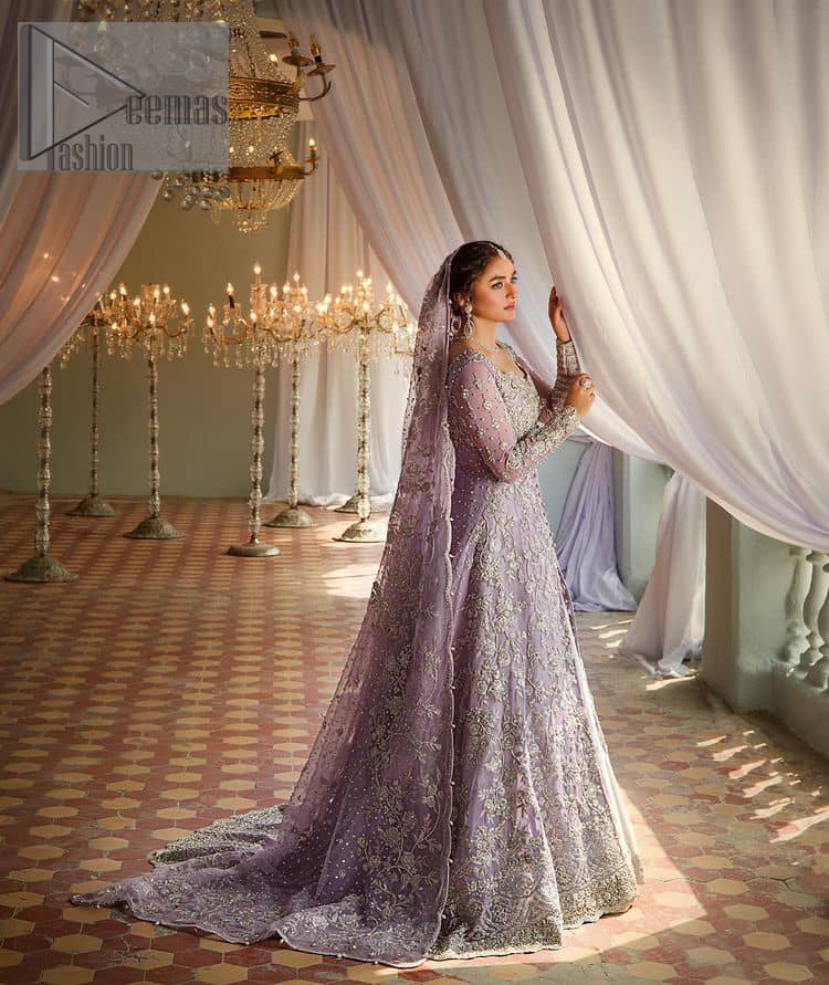 Bold instruments on a bright canvas make a true fashion statement. Introducing a lilac outfit for your Walima day to boost up your day. The front open gown in lilac colour looks as amazing as any bride's dream. It is encapsulated with silver embroidery which contains crystal, tilla, dabka, kora and sequins spray all over. In addition to this, it is highlighted with a sweetheart neckline to enhance the beauty of the gown when combined with full sleeves. It is systemized with silver barcode sharara finished with silver border embroidery that enhances the look of the bride during the day as well as night events. Complete this lilac article with a dupatta which is ornamented with four-sided borders and sequins sprayed all over. 