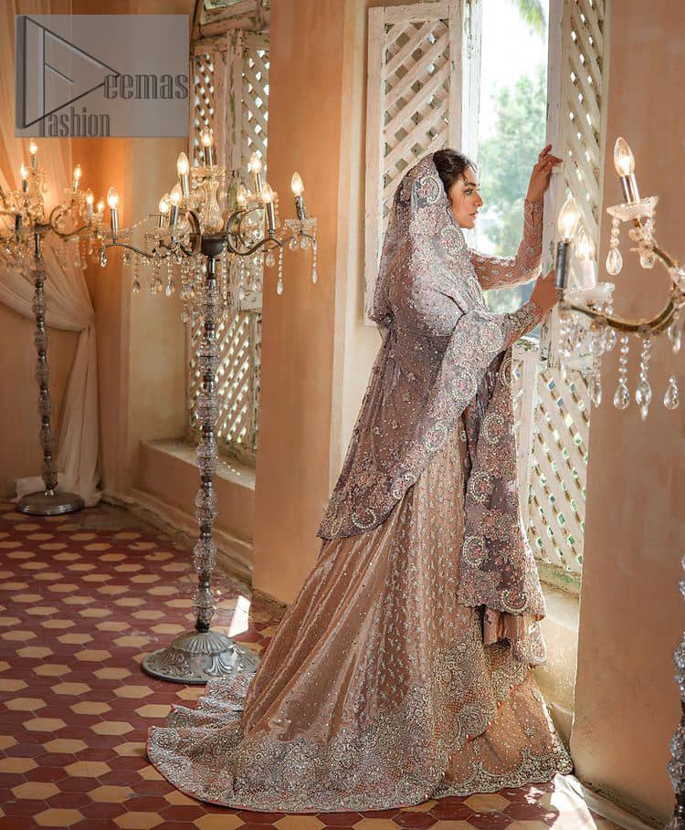 Amplify your style on your Walima day in this stunning light color. DeemasFashion presents the super handsome rose gold outfit for you. First of all, which includes back train maxi in the rose gold colour. It is prominent with the silver embroidery that is encrusted with pearls, silver crystals, kora, dabka and sequins all over highlighting floral patterns. Further, it is emphasized with boat shape neckline and full sleeves that increase the opulent statement of the outfit. It is organized with rose gold sharara which is also embellished with heavy silver embroidery to make your day super dazzling. Finish this look with the rose gold dupatta that is accentuated with sequins and booti spray all over and adorned with a four-sided matha Patti border. 