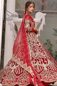 Marry someone who makes your heart shine. Wear what makes your soul shine. Introducing this Pakistani reception outfit which begins with a red blouse which is laboriously hand-rendered with silver embroidery to make your day super bright as silver colour. Further, it is highlighted with tilla, dabka, kora and crystal. The blouse of this Pakistani reception outfit is enhanced with boat shape neckline and three-quarter sleeves. The following blouse of the Pakistani reception outfit is systemized with a panelled lehenga in the same colour which is again heavily embellished. Complete this outfit with a frilled dupatta which is embellished with two-sided borders and sequins sprayed all over to make you shine.