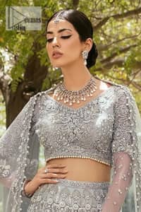 The magic of luxurious romantic outfits, giving you love at your Walima. The outfit defines the endless beauty of the immaculately produced pieces with intricate silver and golden embellishments, which are further magnified wth tilla, dabka, kora, Kundan and crystal. The full sleeve style of the blouse along with V shape neckline just gives you a unique way of artistic look. It is systemized with frilled lehenga which is heavily embellished with floral patterns to make your day more charming and delightful. Complete this article with a dupatta which is embellished with a four-sided border and ting floral motifs all over that are a dream of someone's special moment.