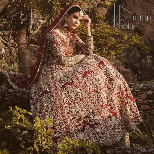 Love is in the air. A maroon blouse in maroon colour is hand-rendered in gold and is enhanced with naqshi,