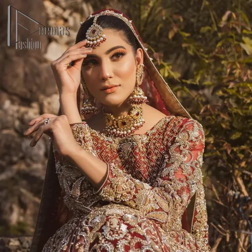 Love is in the air. A maroon blouse in maroon colour is hand-rendered in gold and is enhanced with naqshi,