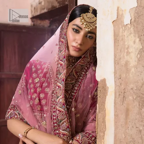 Blissful Pink! This ensemble is the epitome of grace. A shocking pink lehenga is heavily adorned with floral patterns. The