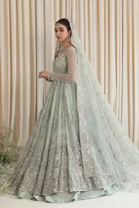 Exquisitely designed ensembles with delicate embroideries & traditional embellishments for nikah outfit statements. This beautiful maxi that comes in aqua blue colour is beautifully embellished with crystals and zardozi work. Beads, motifs,tilla, dabka, sequins, and shimmering adornments enhance the overall charm of this alluring maxi. Perfect stitching and intricate details give a royal appearance to the Bride. The bodice has a delicate and feminine V shape neckline with embellished full sleeves. Paired with lehnga and an alluring dupatta with a heavy spray of sparkling sequins and a detailed head embellished border to make your day super charming.