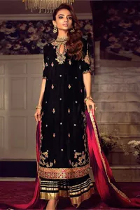 This outfit glam up in our detailed embroidered fabrics made to make you shine for every occasion. The black long shirt in premium quality velvet is beautifully decorated with multiple colour embroidery which is further enhanced with tilla, dabka, kora, Kundan and the real magic of Zardozi. The following shirt has an embellished neckline to meet the trending grace. Further, the half sleeves are adorned with floral motifs. It is coordinated with sharara in the same colour to balance the overall royal look of this party wear. Complete this article with a dupatta in the double shade that is a beautiful piece for a bridesmaid who has a unique taste.