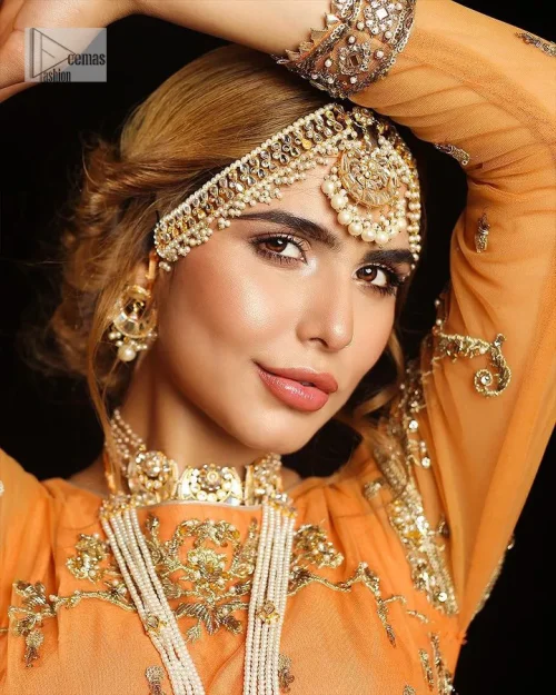 Fun colours, fresh you.  This breathtaking blouse in light orange colour is gracefully adorned with hand-crafted embellishments and lavish golden