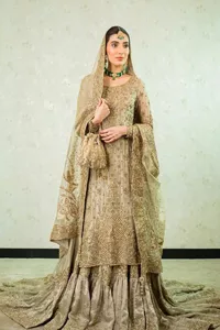 Comfy is a mood. The latest style of shirt sharara in high-quality fabric detailing with light gold gota, zari, dabka, sequence, naqshi, stones & tilla work all over the outfit. Full embellished shirt with full detailing and heavy neckline design with high-quality inner. Further, the beautiful floral motifs are adorned on sleeves to make this masterpiece super aesthetic It is coordinated with sharara with heavy embroidery on the border. The floor-length sharara gives a unique look. Complete this walima wear with a dupatta adorned with four-sided embellished frames and sequins sprayed all over.