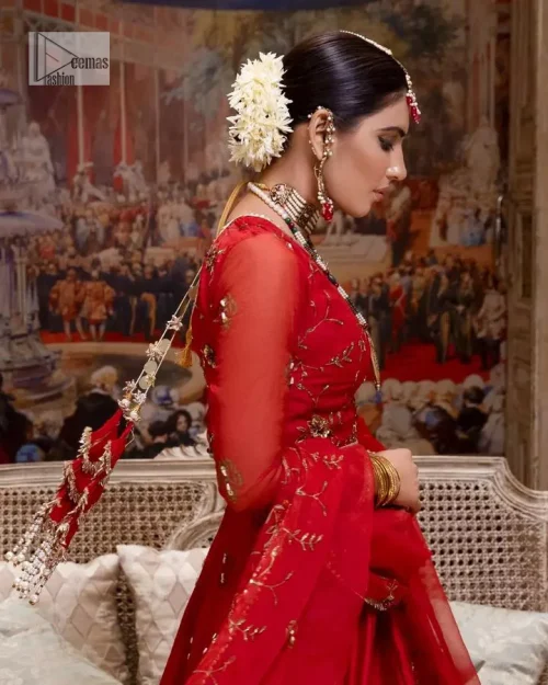 Statement suiting in red. This red blouse comes with a lehenga and dupatta in premium fabric quality. The blouse is