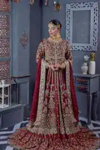Bold and classy colour for the reception outfit! The maroon gown is breathtakingly adorned with hand-crafted embellishments and intricate designs. It is enhanced with tilla, dabka, Koran, Kundan and details of Zardozi. The round neckline is emblazoned with golden embroidery to make this masterpiece romantic. The full sleeves of the following scalloped gown are adorned with fine details. It is paired with flared lehenga which is also heavily embellished giving a royal look to the gorgeous bride. Finish this maroon outfit with a dupatta which is ornamented with four-sided borders and sequins sprayed all over to create an exquisite dress.