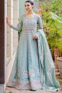 Introducing our stunning sky-blue Walima outfit, a masterpiece of artistry and elegance. This attire showcases a harmonious fusion of traditional and modern design elements, adorned with intricate silver embellishments that include tilla, dabka, kora, Kundan and the real magic of Zardozi. The flowing maxi and lehenga both provide comfort and style, ensuring you radiate confidence on your special day. The fused lehenga is offered in a rich, sophisticated colour palette, ensuring you steal the spotlight with your regal presence. Finish this article with a dupatta framed with four-sided embellished borders and sequins spray.