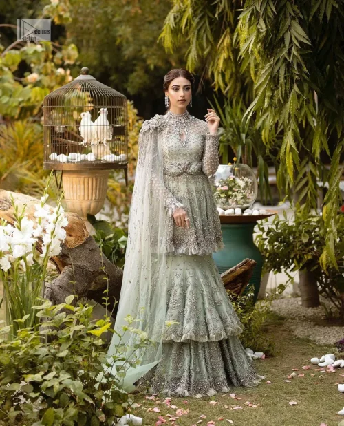The flowing peplum jewel neckline is coordinated with double layers of lehenga to ensure a comfortable and stunning fit, while