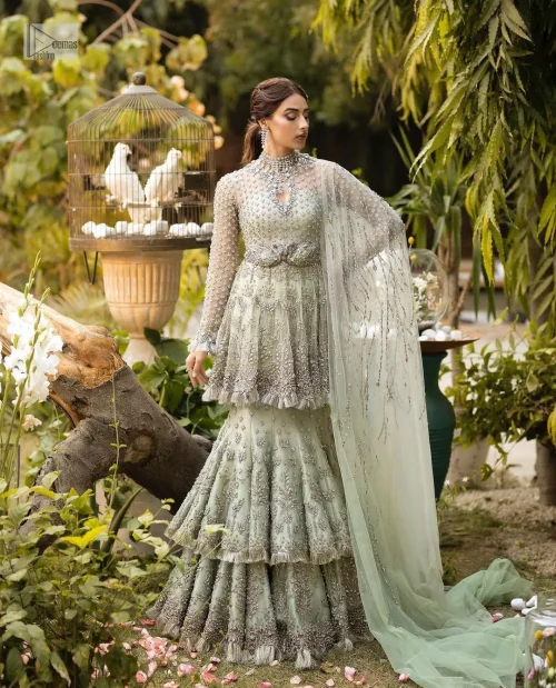 The flowing peplum jewel neckline is coordinated with double layers of lehenga to ensure a comfortable and stunning fit, while