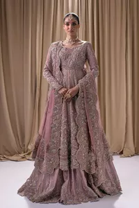 Stand out and stay pink with this nikah wear! The delightful article in pink colour is a traditional masterpiece that will give the gorgeous bride a head-turning look at the wedding. The frock has a sweetheart neckline to make this outfit lovely. It is adorned with silver and golden embroidery which is magnified with tilla, dabka, Koran, Kundan and the details of Zardozi. Further, the combination of tiny and large floral motifs on full sleeves provides a perfect finishing look to this masterpiece. It is paired up with a lehenga in the same colour making it an epitome of beauty and grace. Finish this with a dupatta framed with four-sided embellished scalloped borders and tiny floral motifs all over.
