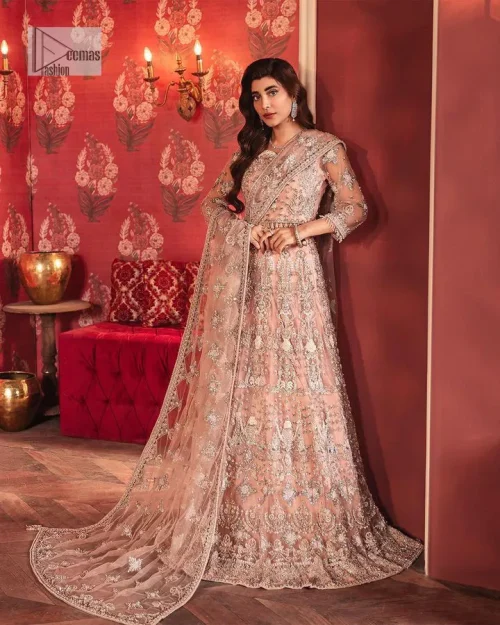 The beautiful outfit comes has an alluring peach colour and is gracefully emblazoned with embroidery. Hand-crafted details of tilla, dabka,