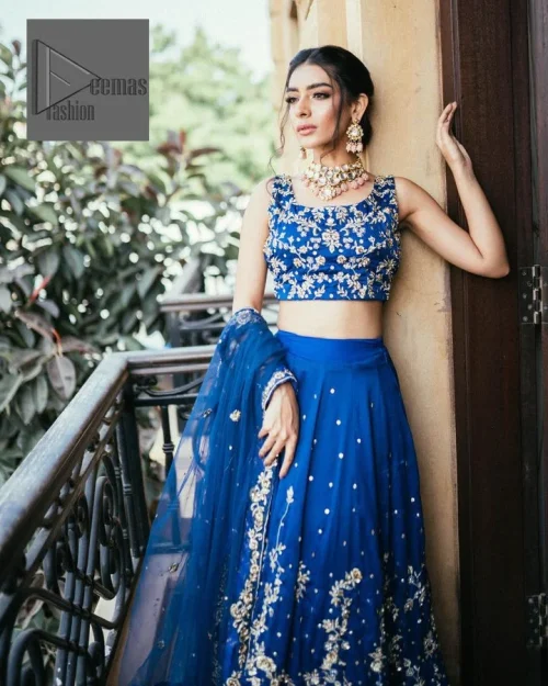 The sleeveless style adds a touch of allure to this already captivating outfit. It is paired with an embroidered lehenga