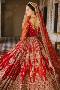 Elevate your wedding day with a touch of elegance and charm, as you shine in this extraordinary reception outfit. Completed this article with a dupatta framed with four-sided borders and kiran lace.