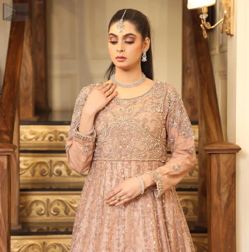 The scalloped hemline of the outfit adds a whimsical touch.