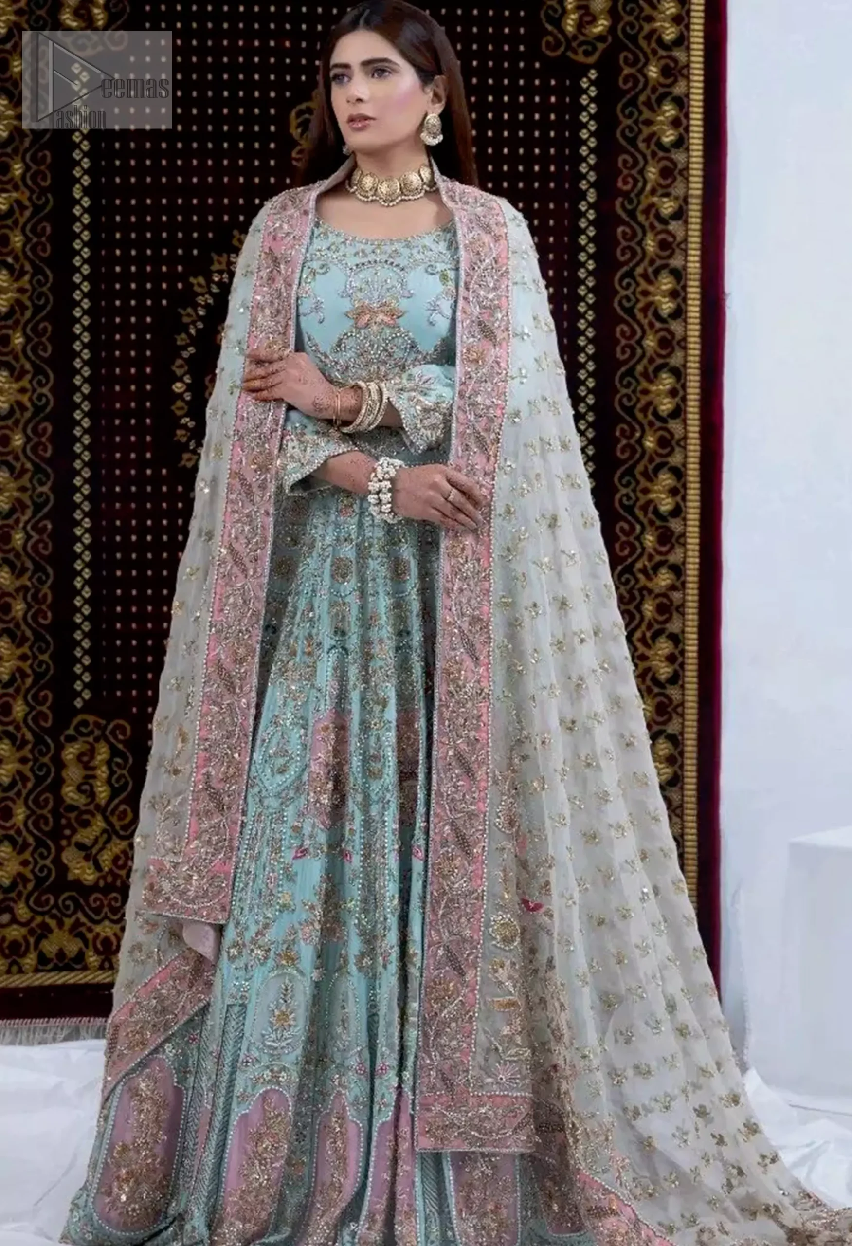 complementing the ethereal ivory elegantly designed dupatta with a pink appliqued border and scattered tiny floral motifs all over the ground. Command attention and feel regal on your special day in this exquisite bridal attire.