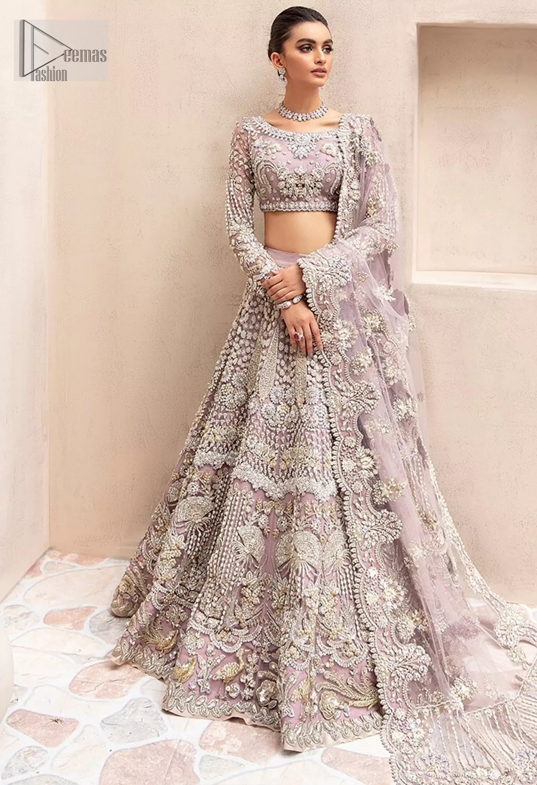 This enchanting ensemble captures the essence of sheer grace, with its delicate net fabric and intricate sculptured embroidery.