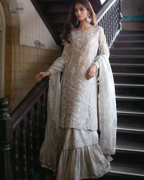 Shimmering beige zari net shirt and wide-flare farshi gharara styled for a celestial Nikkah ceremony.
