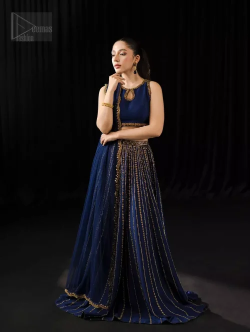 Its scalloped edges trace delicate artistry, while the dupatta rests in quiet poise.