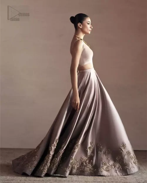 Light golden embroidery adds a gentle, luxurious touch.